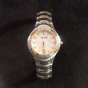 Bulova watch. Has 4 links to fit. Tells date. Diamond chips in and out.